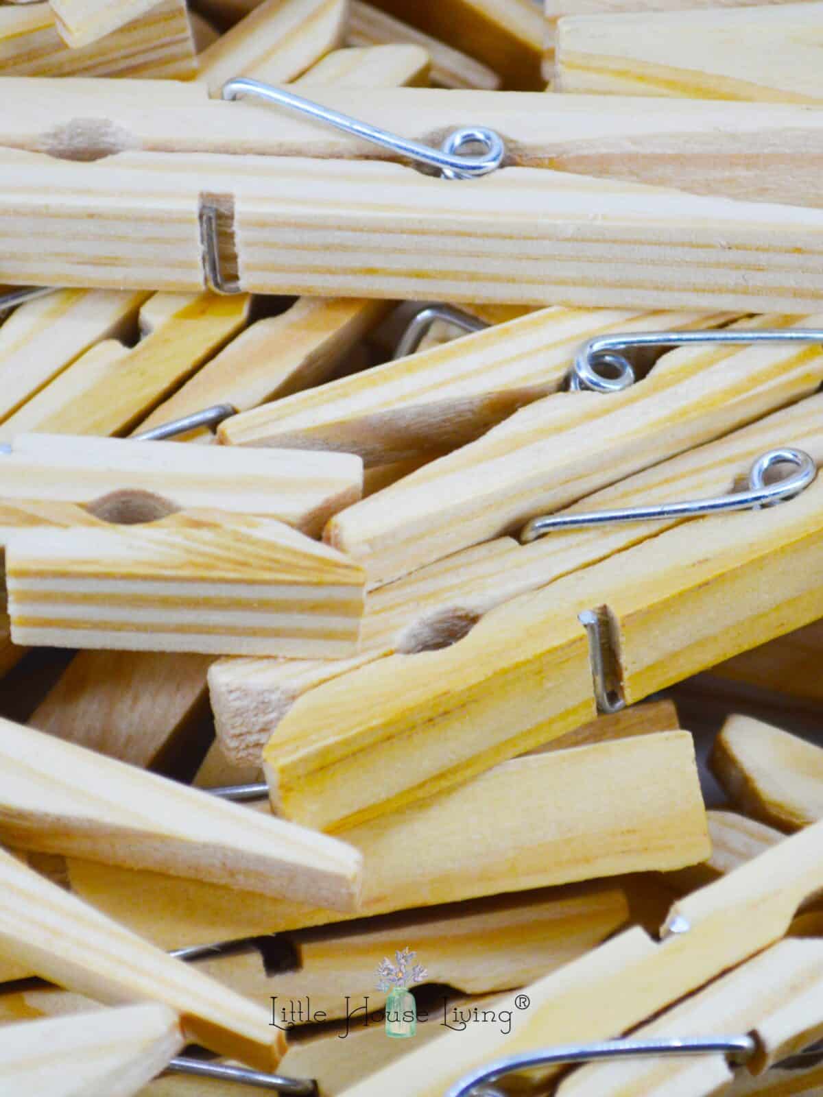 Wooden clothespins in a pile.