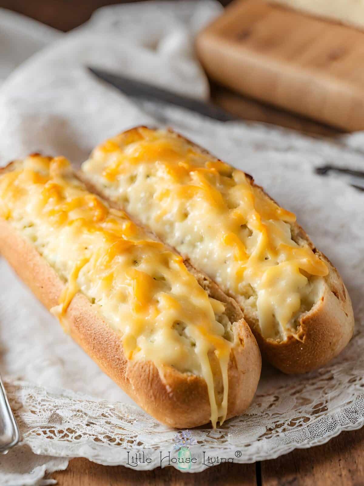 Cheesy French bread on a lace placemat on a wooden table.