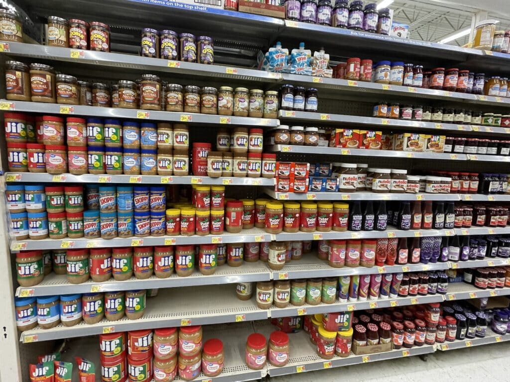 Grocery shelves filled with peanut butter