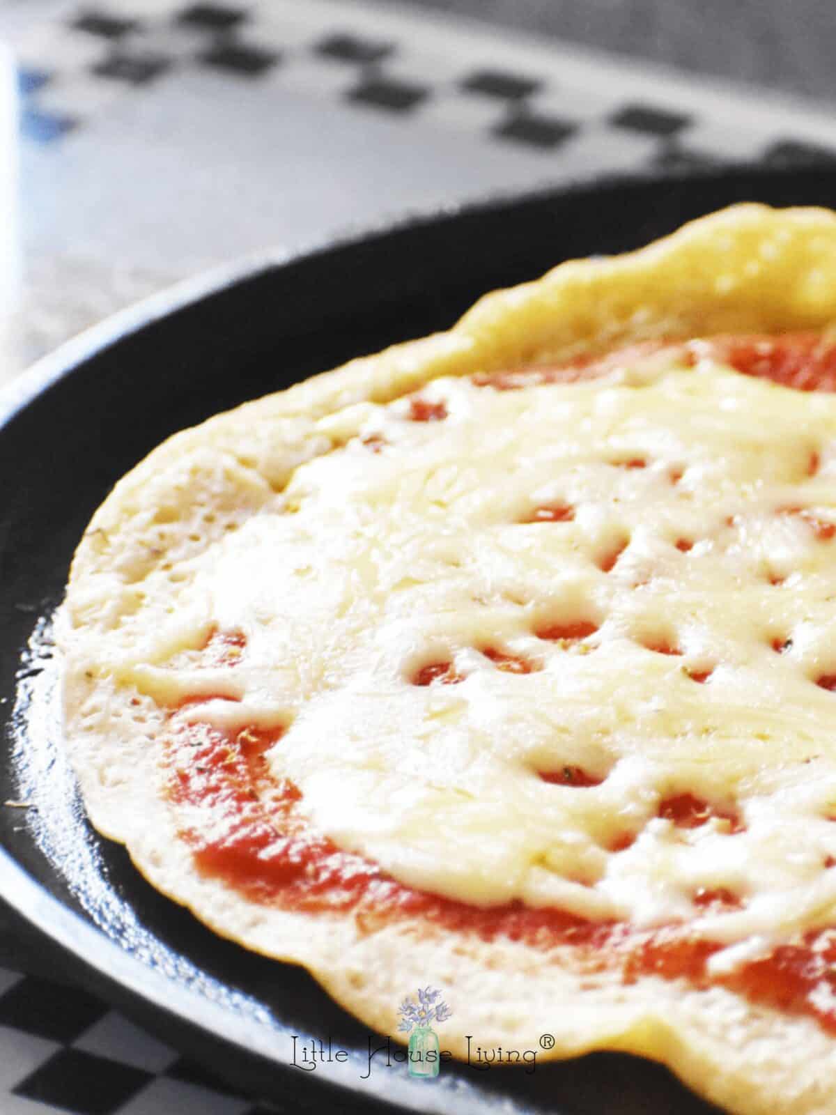 Sourdough Pizza crust in a cast iron griddle.