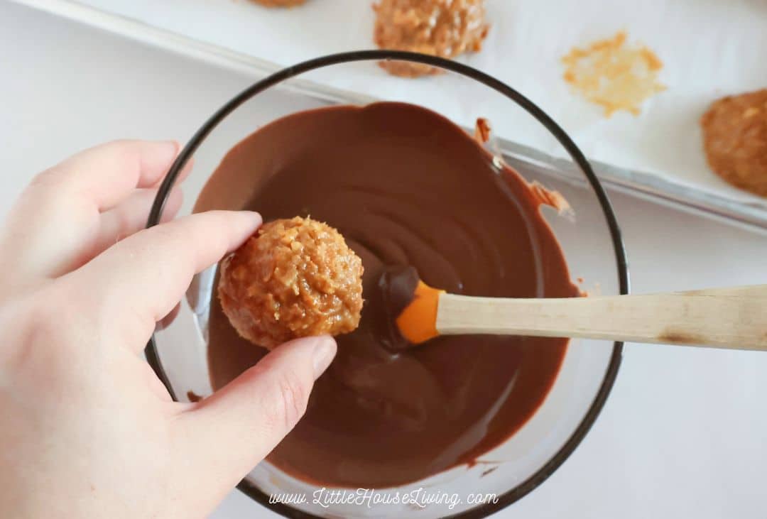 dipping a samoa truffle into melting chocolate