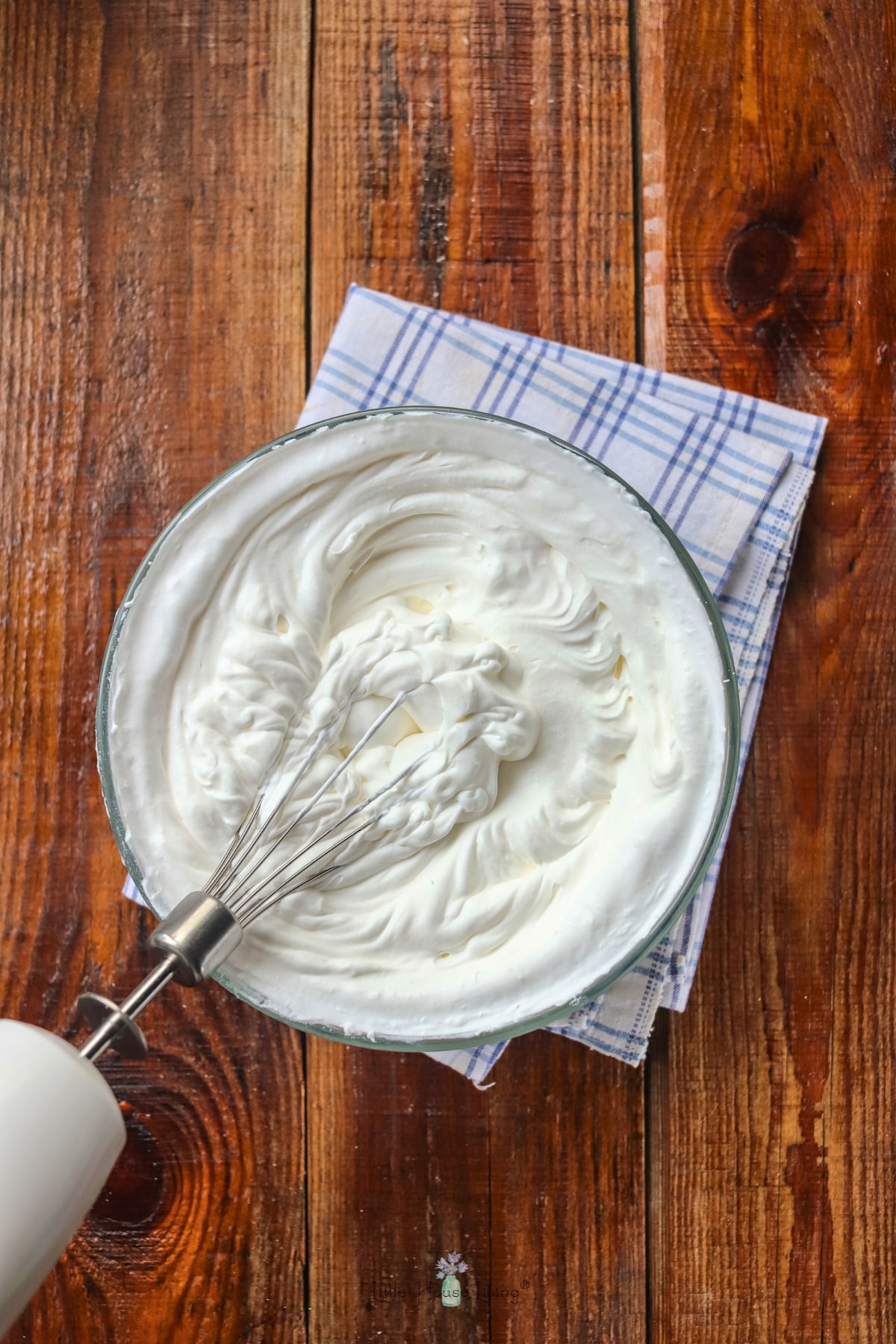 cream cheese frosting in a bowl with an electric mixer