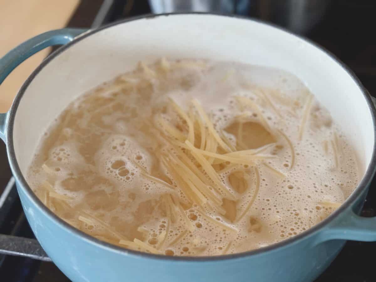Pasta cooking in a blue pot,